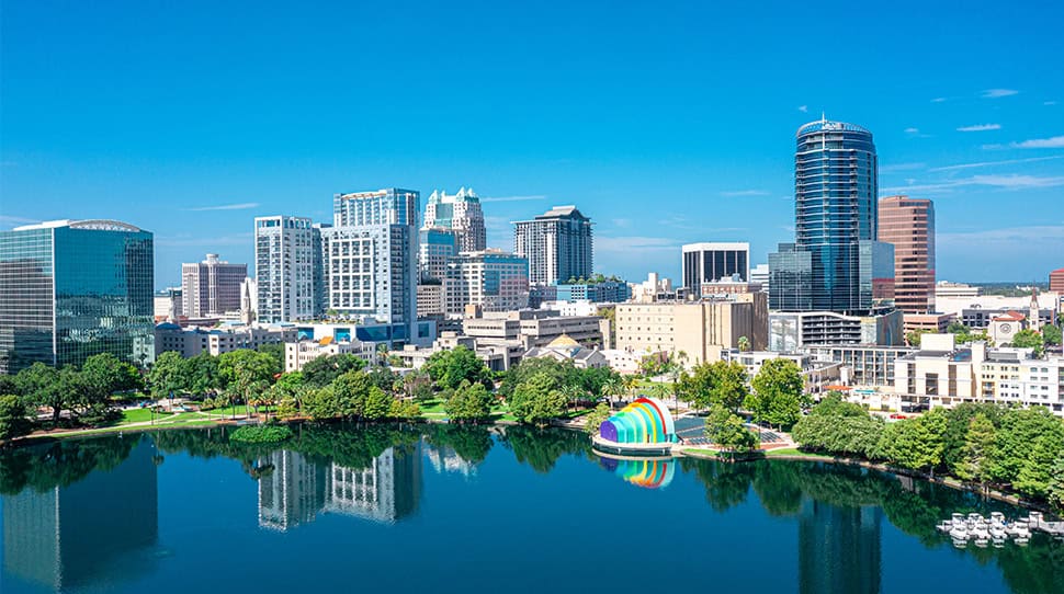City skyline with a lake, promoting UC 2026 registration for homecare professionals.