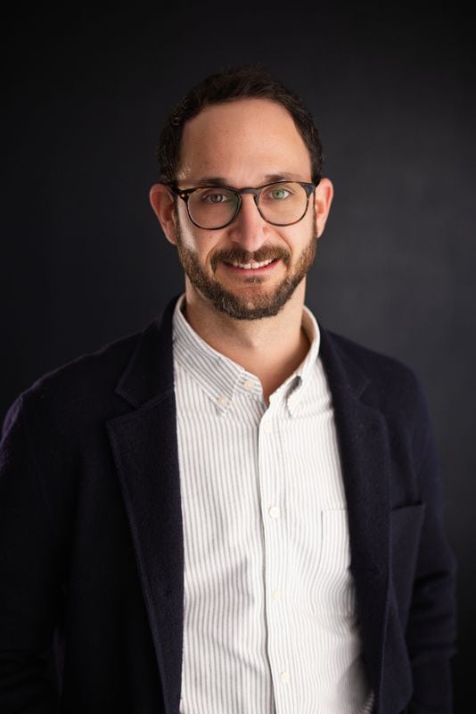 Professional man with glasses in a business setting, representing home healthcare solutions.